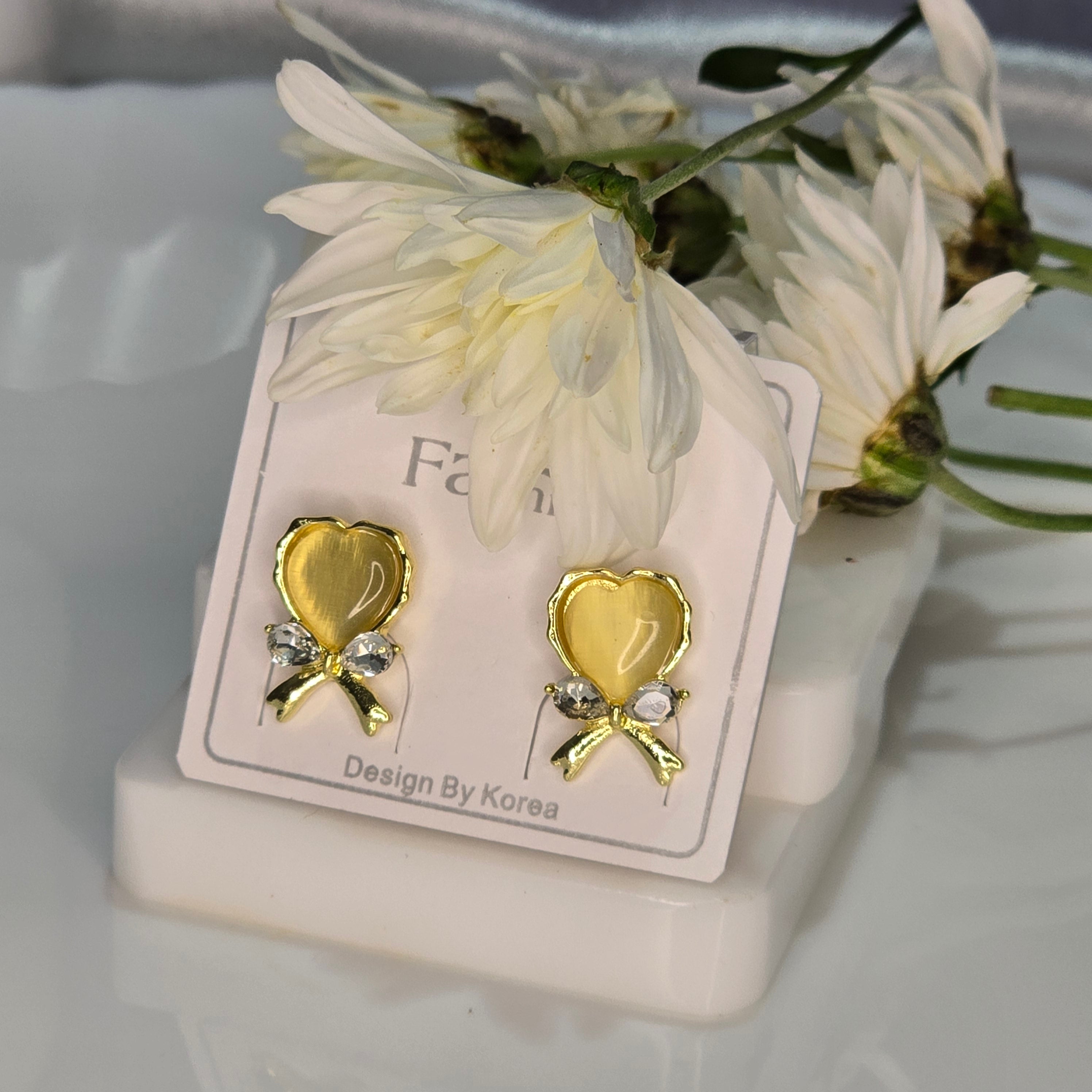 AK00050 - Golden Ribbon Heart Stud Earrings – Korean Bow Design