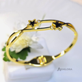 AK00165 - Celestial Star Gold-Plated Open-Frame Bangle with Black Enamel & Crystals