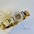 AK00168 - Royal Medallion Gold-Plated Bangle with Crystal Halo & Monogram Detail
