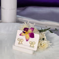 AK00049 - Dainty Bow & Pearl Stud Earrings – Crystal Accented